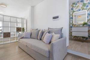 a living room with a couch with pillows on it at Neral relax in Las Playitas