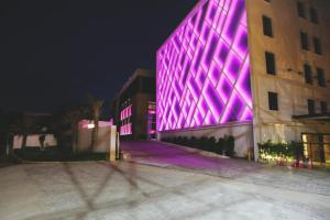 a building with purple lights on the side of it at Banyan Palace in Chennai