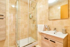 a bathroom with a shower and a sink at Marina De El Morche in Torrox