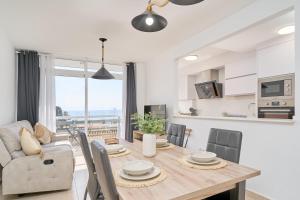 a dining room and kitchen with a table and chairs at Marina De El Morche in Torrox