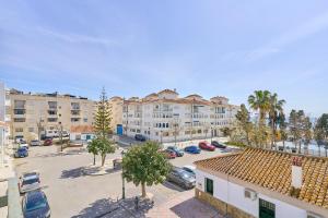 an aerial view of a parking lot with buildings at Marina De El Morche in Torrox