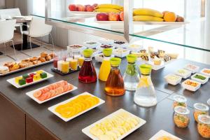 a buffet with many different types of food on a table at NH Collection Wien Zentrum in Vienna