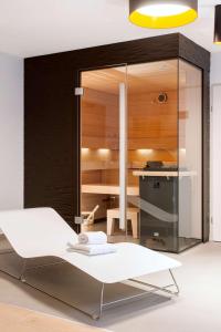 a room with a kitchen with a white table at NH Collection Wien Zentrum in Vienna