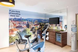 a gym with a wall mural of a city at NH Collection Wien Zentrum in Vienna