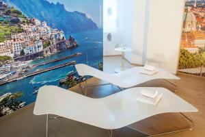 two white chairs with a view of the city at NH Collection Wien Zentrum in Vienna +24 photos