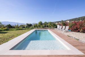 a swimming pool in a yard with chairs and trees at Casa Cándido in Ribarteme