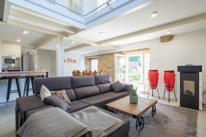 a living room with a couch and a table at Casa Cándido in Ribarteme