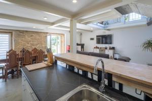 a kitchen with a wooden counter top and a table at Casa Cándido in Ribarteme