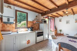 a kitchen with a sink and a stove at Gite Anje in Peyrouse +13 photos