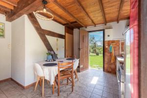 a kitchen and dining room with a table and chairs at Gite Anje in Peyrouse