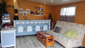 a living room with a couch and a table at La Salamandre in Saint-Agrève