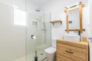 a bathroom with a shower and a toilet and a sink at Villa Carolima - Heated Pool in Benissa +25 photos