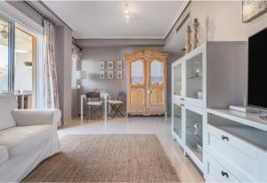 a living room with a white couch and a tv at Denia Living in Denia
