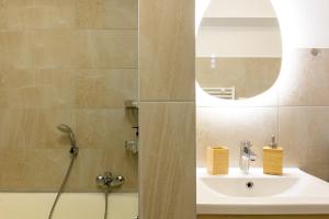a bathroom with a sink and a shower with a mirror at Au Bretzel in Ostheim +12 photos