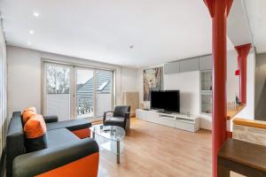 a living room with a couch and a tv at Ferienwohnung Seestern in Wester-Ohrstedt