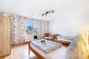 a living room with two beds and a window at Ferienwohnung Seestern in Wester-Ohrstedt