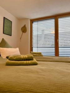 a bedroom with two beds with green pillows on them at Hangout in Neckartenzlingen +14 photos