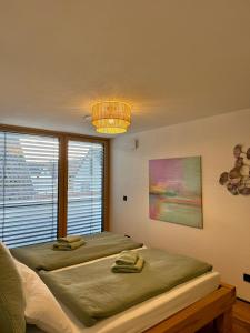 a bedroom with two beds and a large window at Hangout in Neckartenzlingen