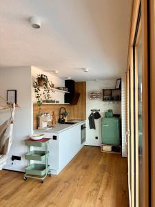 a kitchen with white cabinets and a green refrigerator at Hangout in Neckartenzlingen