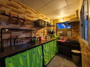 a kitchen with a sink and a counter top at Tilcara Hostal Niña Coya in Tilcara