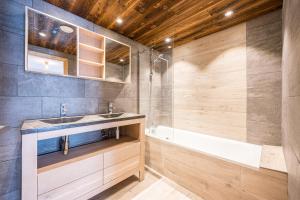 a bathroom with a sink and a tub at Alphonsine Ski Lodge in La Toussuire +18 photos