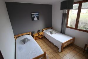 a small room with two beds and a window at Gite La Roseraie in Ruoms +9 photos