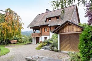 a house with a gambrel roof and a garage at Stecher's Hüsli in Titisee-Neustadt