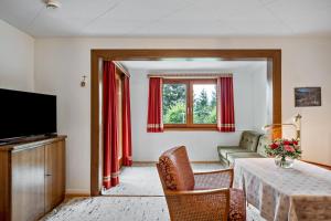 a living room with a couch and a table at Stecher's Hüsli in Titisee-Neustadt