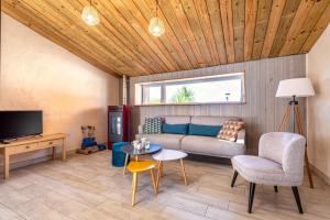 a living room with a couch and a table at Ty Reuniou - La Grange in Cléder