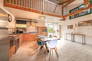 a kitchen with a table and chairs in it at Ty Reuniou - La Grange in Cléder