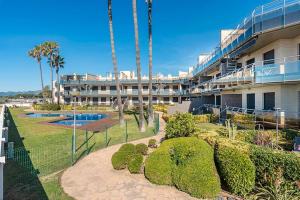 an apartment building with a garden and a swimming pool at Cambrils seaside luxury solarium in Montroig