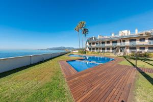 a large building with a swimming pool next to the ocean at Cambrils seaside luxury solarium in Montroig