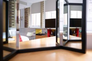 an office with a view of a room with a mirror at Boundary Shoreditch in London