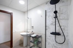 a bathroom with a shower and a sink at Piso arquillo del reloj in Chiclana de la Frontera +19 photos