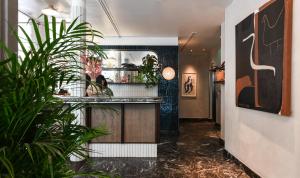 a hallway with plants and a bar in a building at Boundary Shoreditch in London