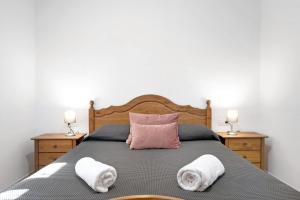 a bedroom with a bed with towels on it at Villa Montenmedio 1 in El Soto +17 photos
