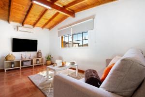 a living room with a couch and a tv at Casa Valentina in Tuineje