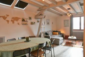 a living room with a table and a couch at Reflets De Montagnes in Chambéry