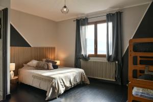 a bedroom with a bed and a window at Reflets De Montagnes in Chambéry
