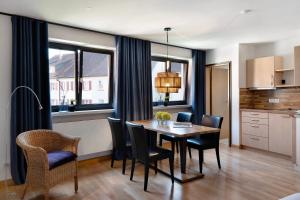 a kitchen and dining room with a table and chairs at 1 Zimmer-appartment Nr 21 in Wangen im Allgäu