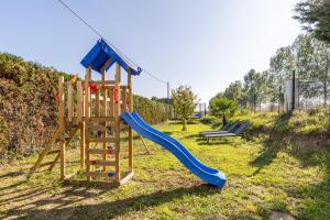 a playground with a slide and a slideintend at Les petits logis de l'Écluse in Noyers-sur-Cher