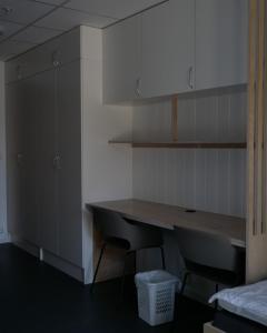 a kitchen with a wooden table and two chairs at Evje Folkehøgskole in Evjemoen