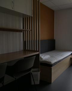 a small room with a bed and a desk at Evje Folkehøgskole in Evjemoen