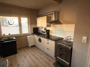 a kitchen with a sink and a stove in it at Ferienwohnung Seus in Dorfprozelten