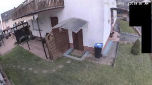 a house with a wooden door and a balcony at Ferienwohnung Seus in Dorfprozelten