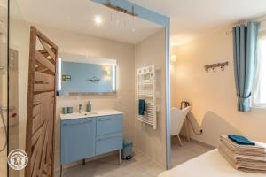 a bathroom with a blue sink and a shower at Notre Petit Paradis in Annecy +69 photos