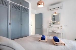a bedroom with a bed with blue towels on it at Puerto Chico E in Playa Blanca +20 photos