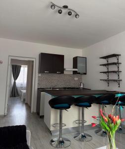 a kitchen with a counter and stools in a room at Waterfall apartment in Plitvička Jezera