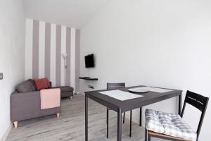 a living room with a table and a couch at La Corte A2 in Antigua +13 photos