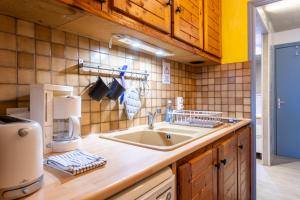 a kitchen with a sink and a coffee maker at L'Alpazen Jouve Studio Terrasse in Saint-Véran +13 photos